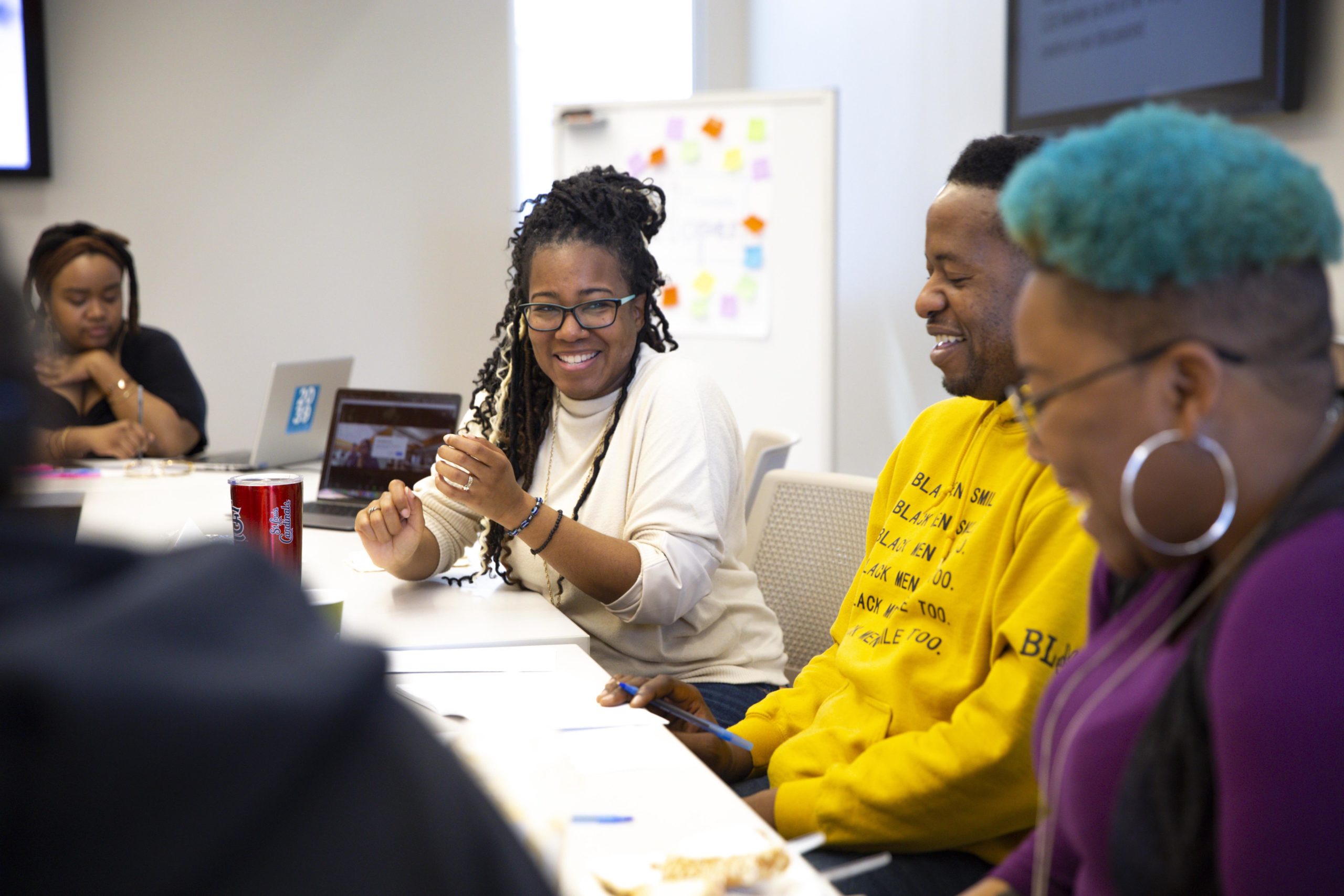 Community Governance Board members discussing and laughing