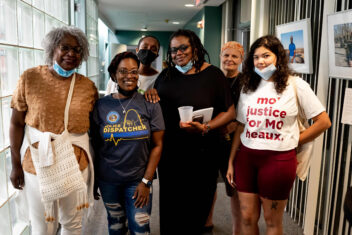 Photo of St. Louis residents at Thomas Dunn Learning Center. From left to right, there is an older Black woman with curly hair with a mask under her chin, a knit top and bag, Erricka Moorehead, a Black 911 dispatcher wearing a t-shirt, Patrice Hill, a Black former Racial Healing + Justice Fund Community Governance Board member in an all black outfit with glasses and a mask under her chin, a femme with short hair and light skin with a white shirt that says mo justice for mo heaux and short magenta pants. In the back is Sara Nixon, a bald Black person with a mask on. They are all smiling.